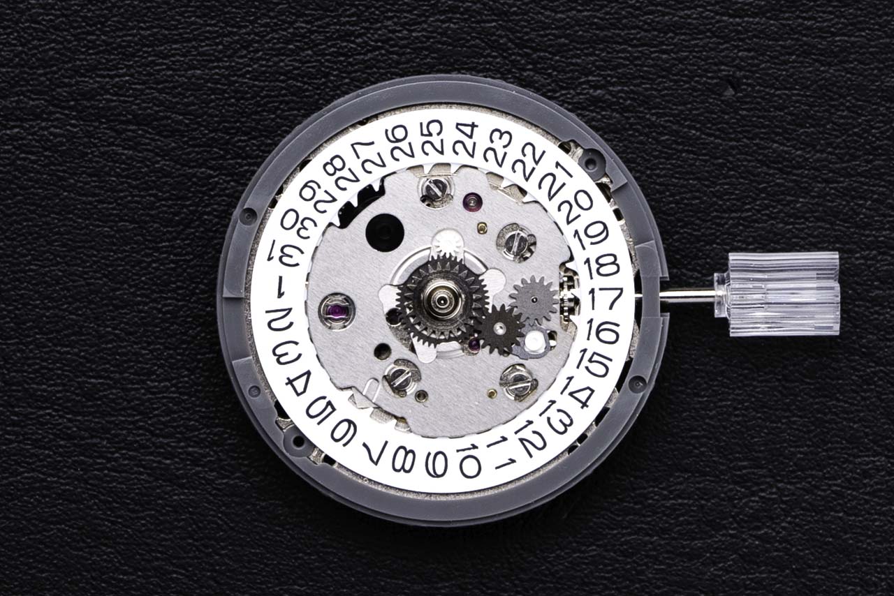 Seiko NH34A (aka 4R34) GMT movement with plastic holder. An automatic GMT movement by TMI that is compatible with Seiko 5 Sports GMT movement
